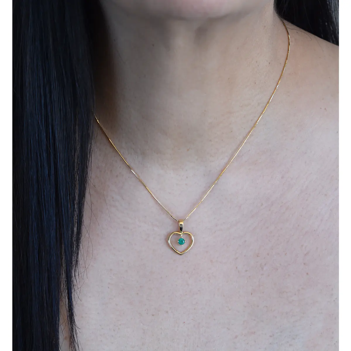 The excellent quality of the round emerald and the rich yellow color of the heart shape make this pendant colorful and unique as shown on the models neck