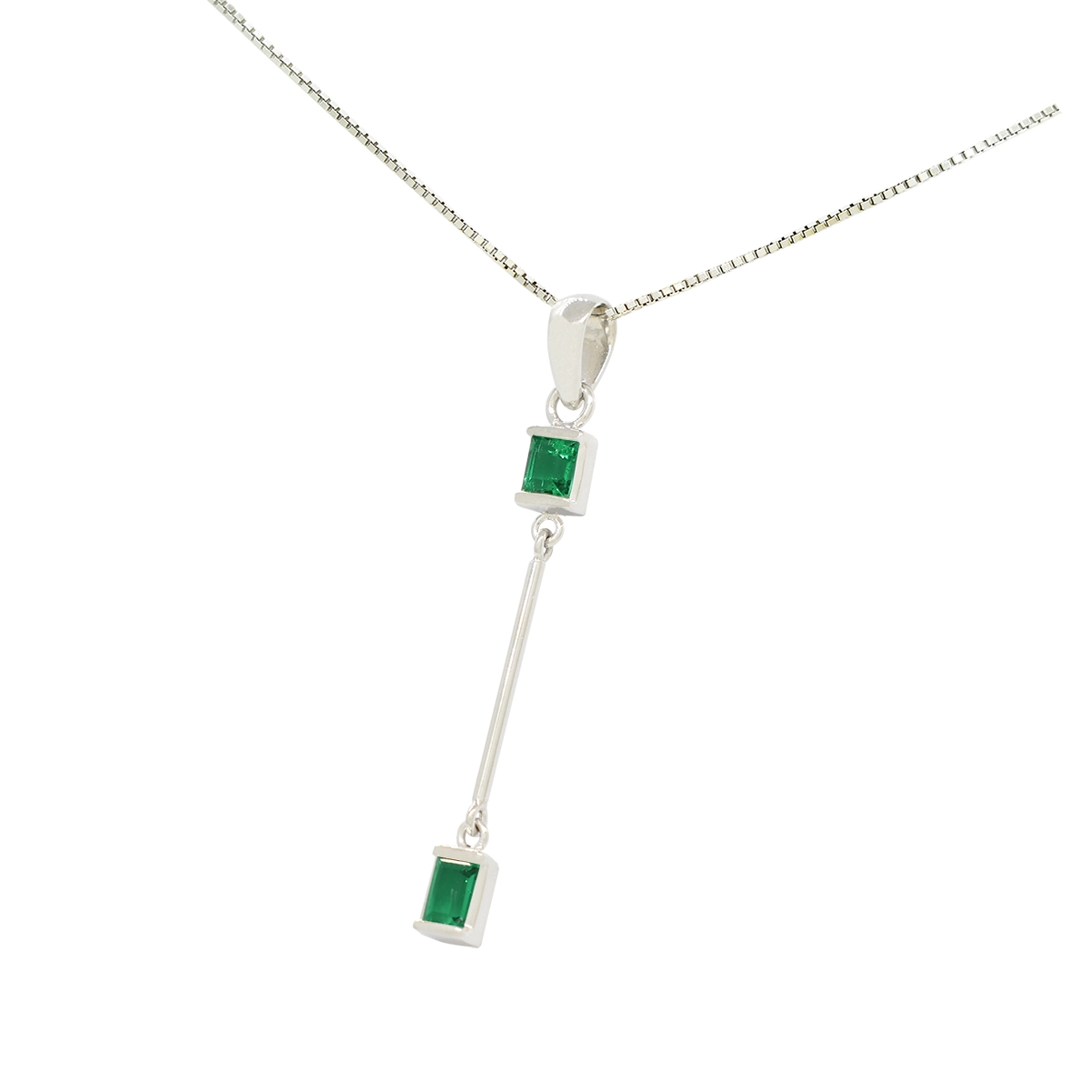 Fine emerald pendant with dark and brilliant green color real Colombian emeralds set in half bezels, one at the top and one at the bottom of a thin 18K white gold pole