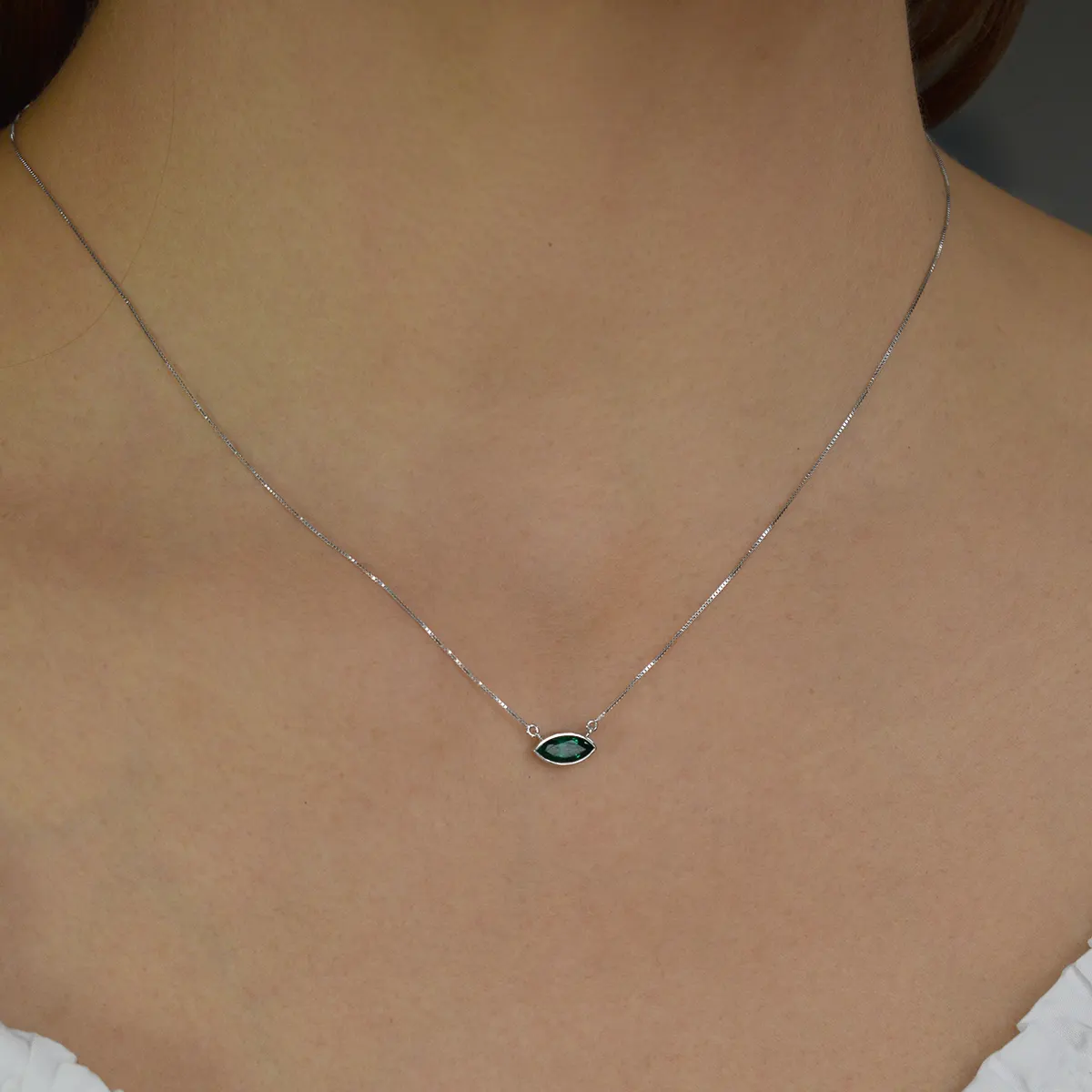 Muzo mine natural Colombian emerald with stunning dark green crystal beautifully set in a single stone solitaire necklace design in white gold