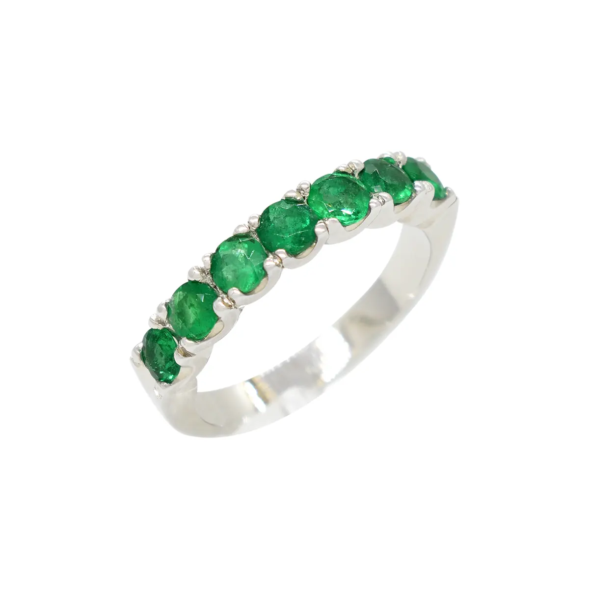 Emerald wedding band ring in 18K white gold with dark green natural Colombian emeralds in classic prongs setting