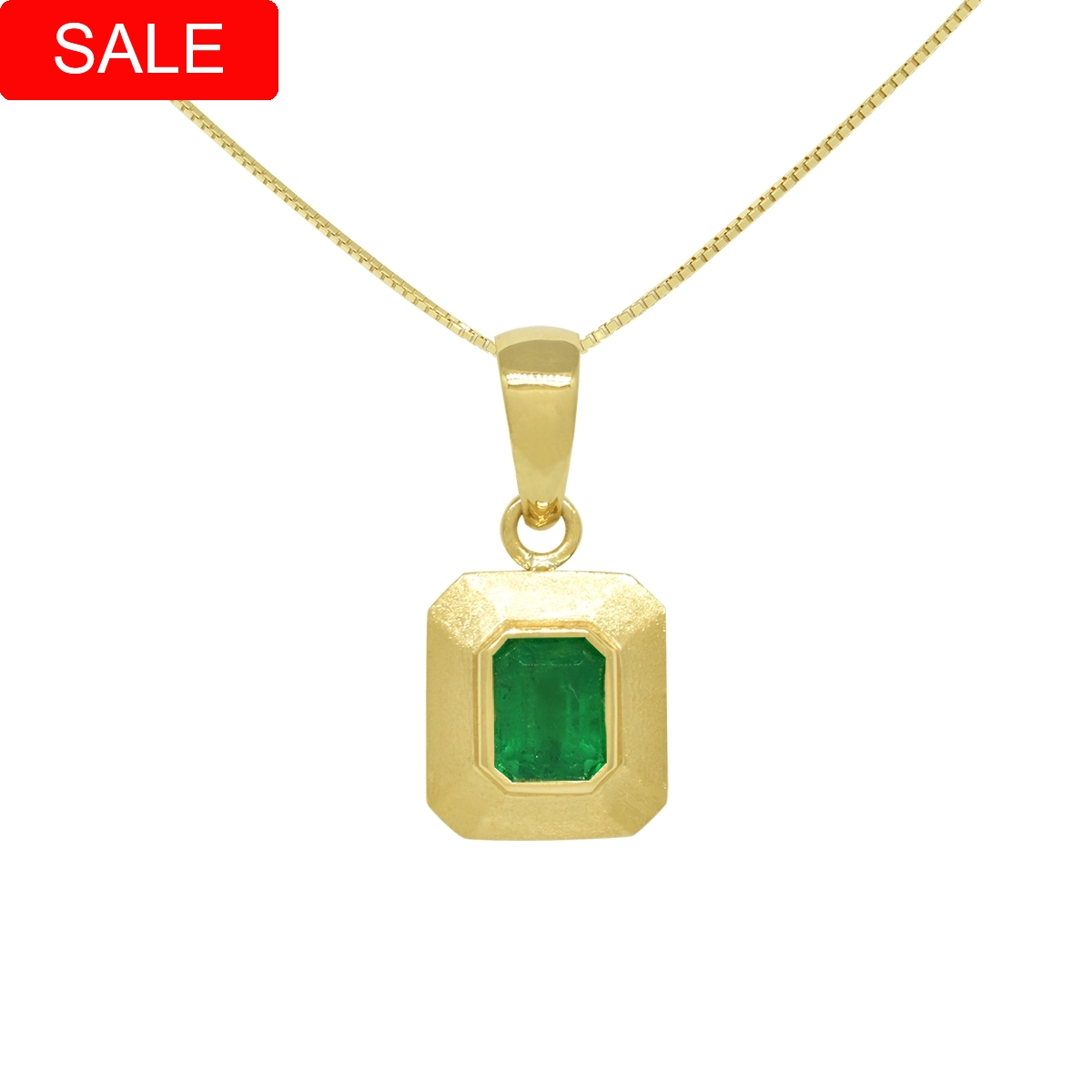 Emerald cut natural Colombian emerald pendant necklace set in solid 18K yellow gold bezel set with brush finish creating a rich texture around the gem