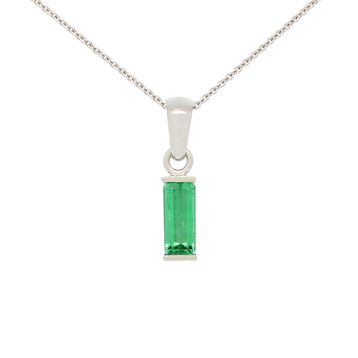 Emerald cut emerald pendant necklace in 18K white gold half-bezel setting with gold bars at top and bottom