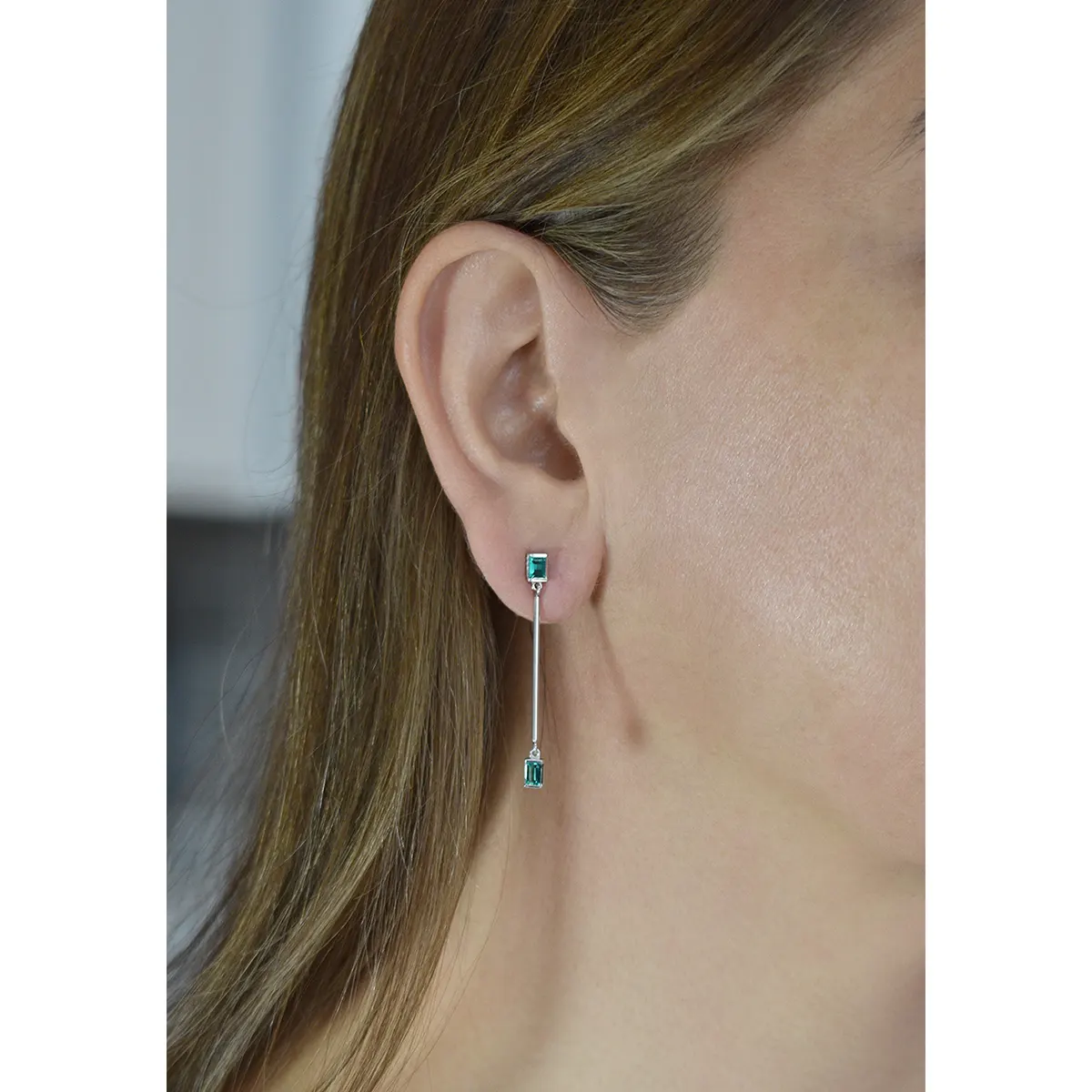 The top part of these drop earrings goes on the earlobe. They have custom-made durable butterfly push backs in 18K white gold
